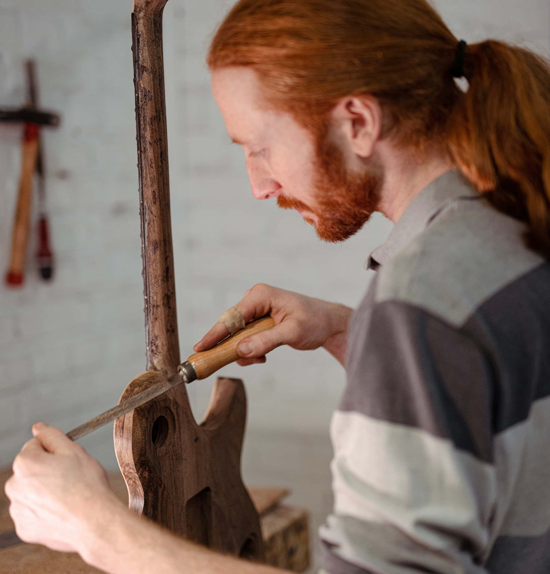 Quentin de Leeuw, Maître Artisan d'Art, façonnant à la main, la commande d'une De Leeuw Custom Shop à l'Atelier De Leeuw à Pont-Sainte-Maxence, lutherie d'art française